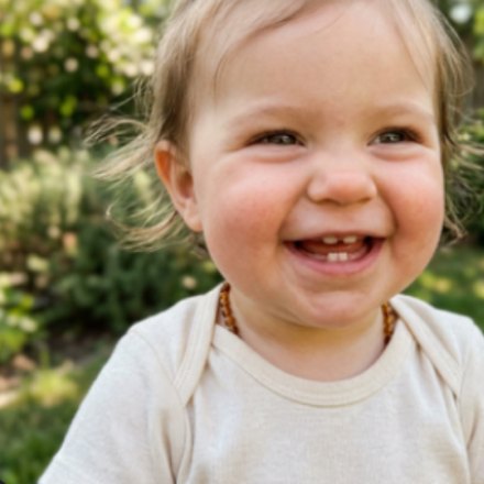 The same child laughing in the garden
